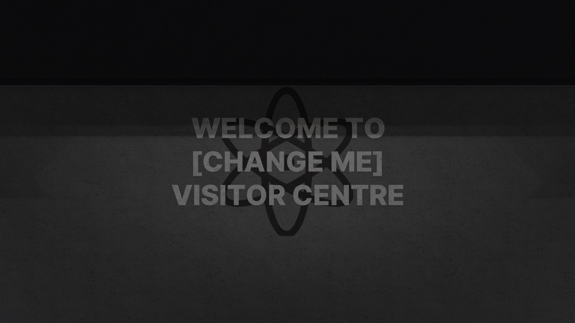 A concrete wall with a atom symbol on it, in front of the symbol is the words 'Welcome to [change me] visitor centre' SIC