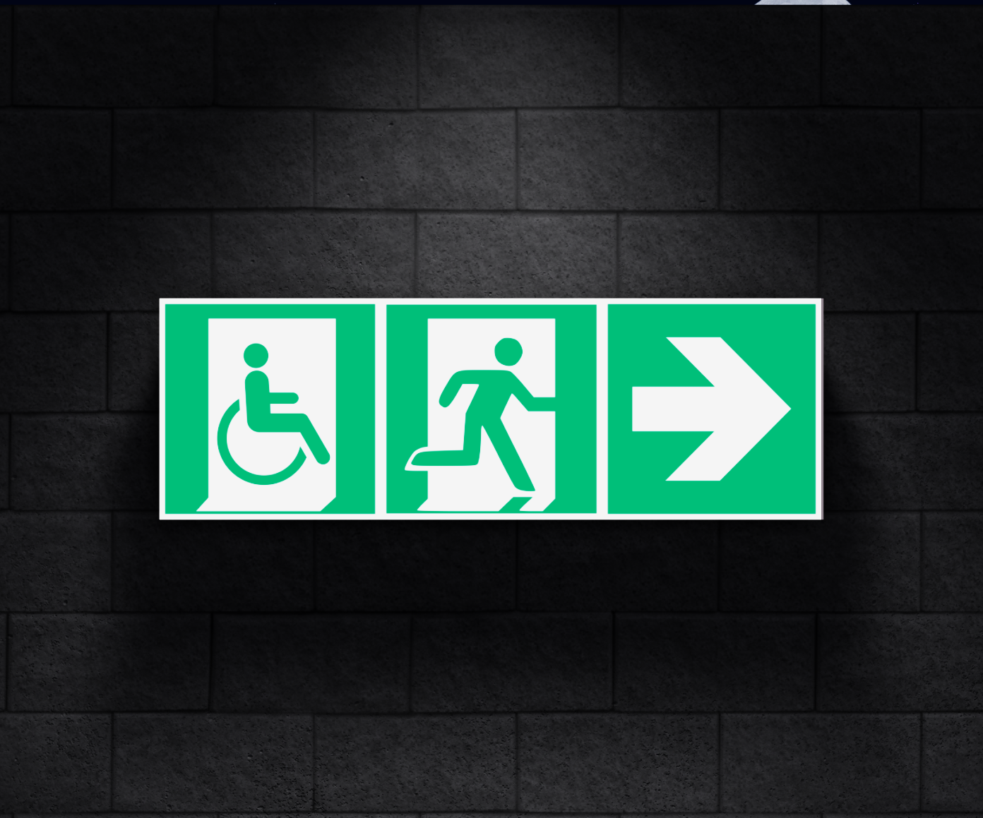 A green exit sign with 3 squares, the first depicts a person in a wheelchair exiting, the second a person running to the exit and the fourth is a leftwards arrow